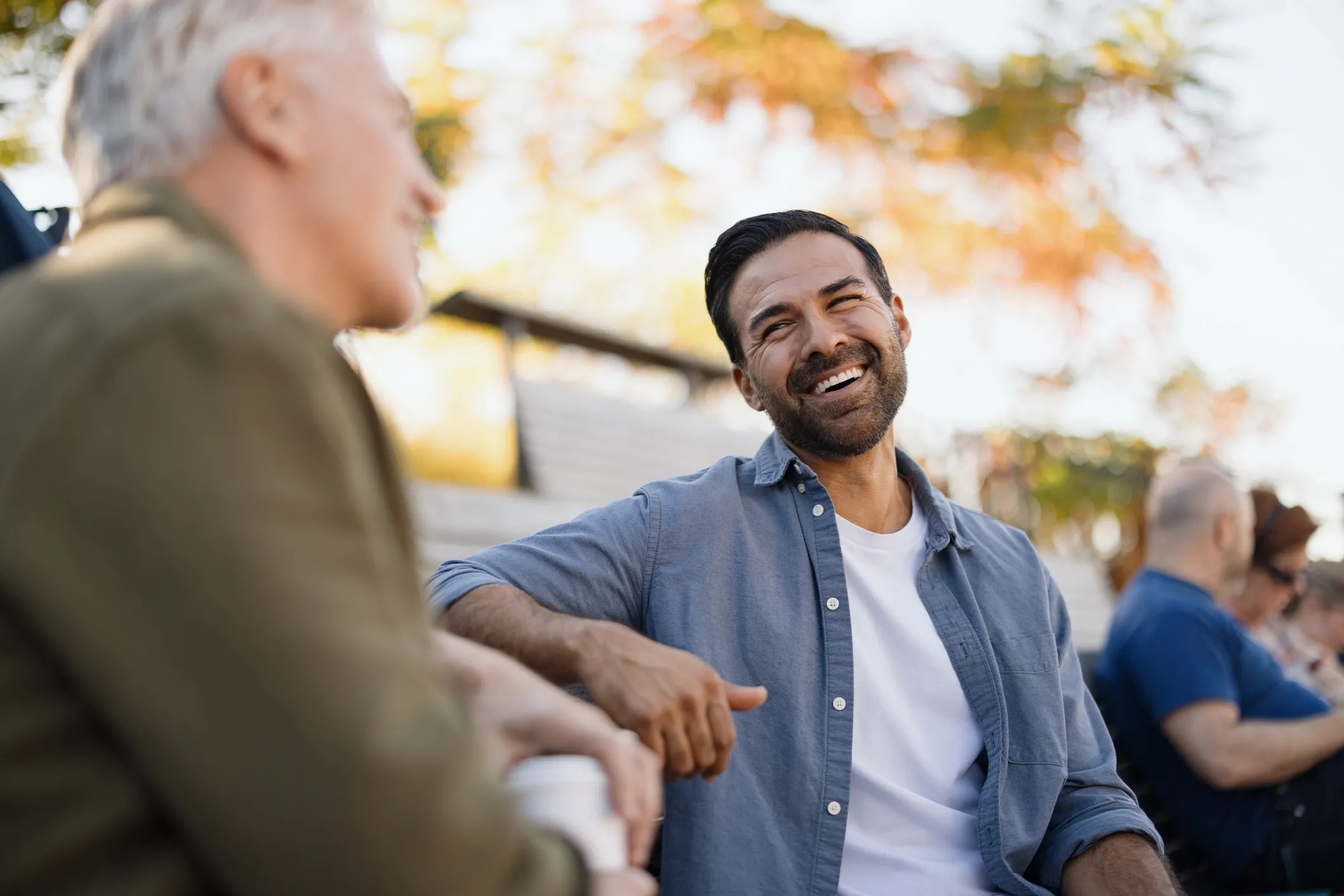 Men laughing together on a porch